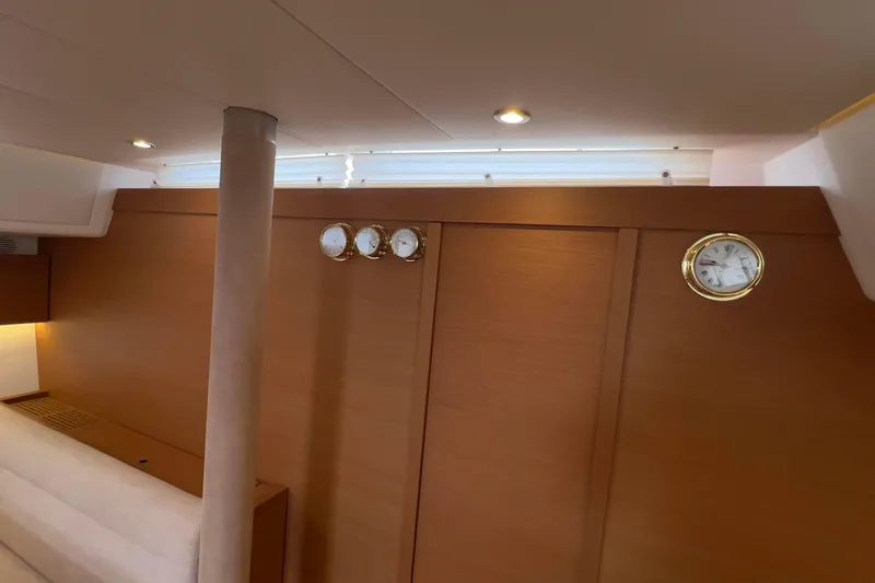  Yacht Photos Pics Interior of 2017 Grand Soleil 52 LC yacht with wooden paneling and brass instruments.