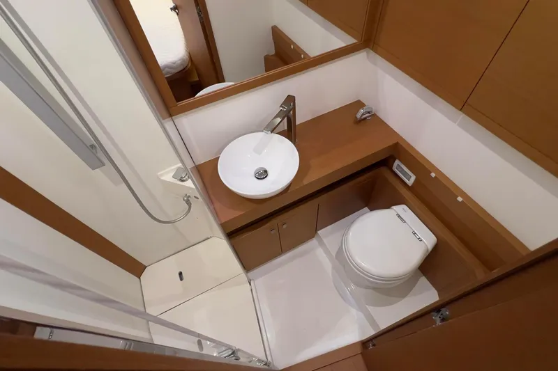  Yacht Photos Pics Luxurious bathroom in 2017 Grand Soleil 52 LC yacht with modern fixtures and wooden accents.