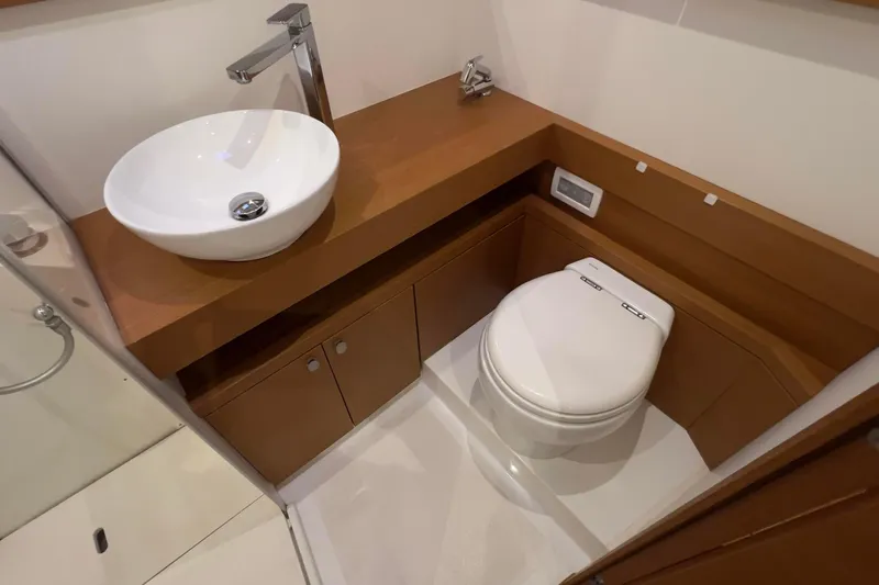  Yacht Photos Pics Modern bathroom on 2017 Grand Soleil 52 LC yacht with sink and toilet.