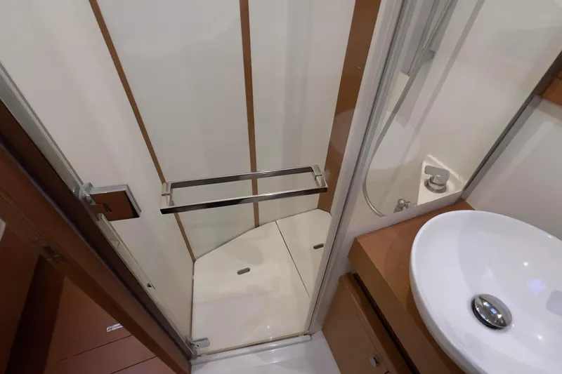  Yacht Photos Pics Modern bathroom interior of 2017 Grand Soleil 52 LC yacht, featuring shower and sink.