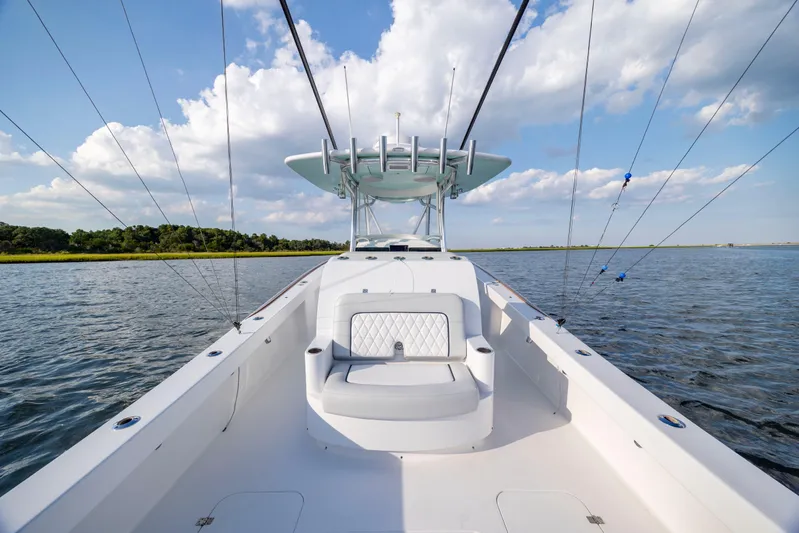  Yacht Photos Pics 2018 Tribute 37 boat on calm water under a blue sky with clouds.