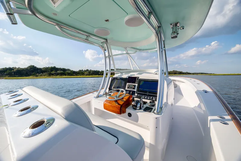  Yacht Photos Pics Cockpit view of 2018 Tribute 37 boat on a sunny day, featuring modern controls.