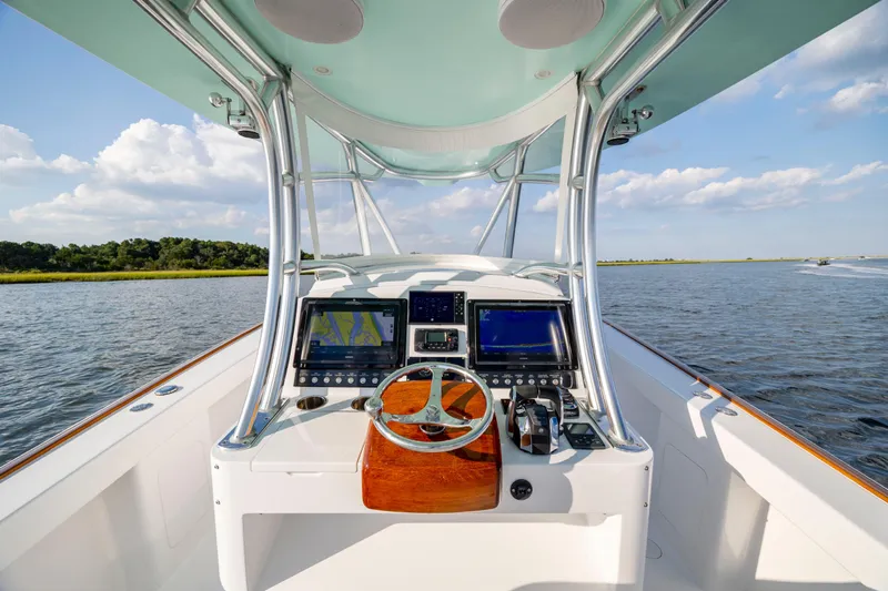  Yacht Photos Pics Cockpit view of 2018 Tribute 37 boat with navigation screens on a sunny day.