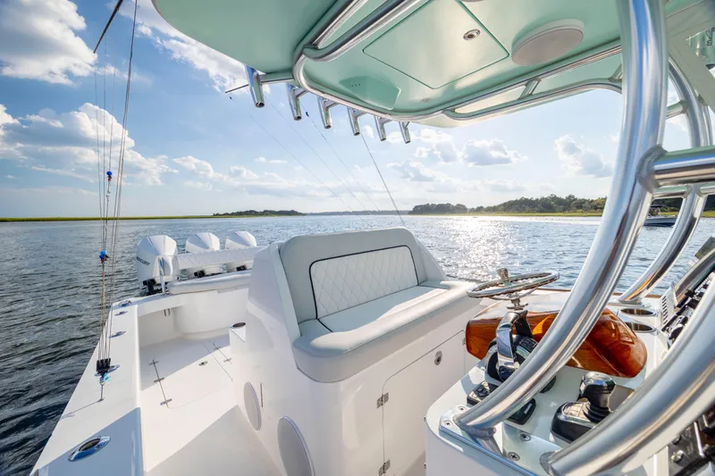  Yacht Photos Pics 2018 Tribute 37 boat interior with helm, ocean view, and clear sky.