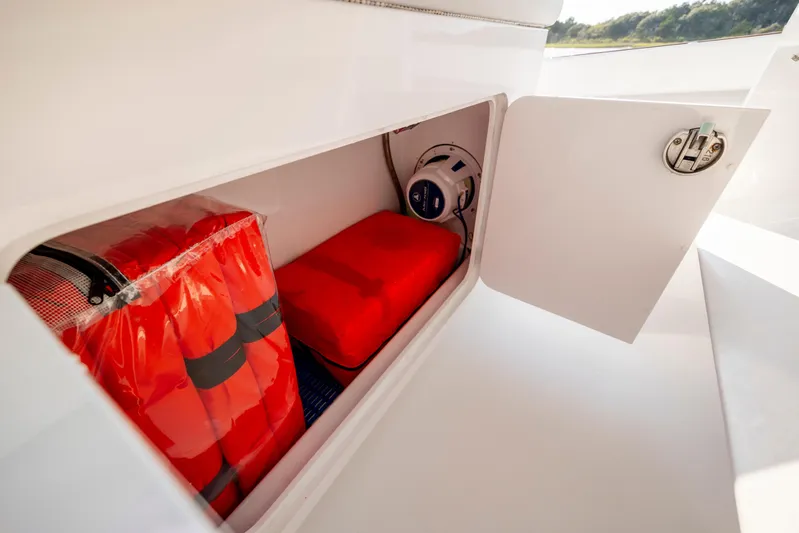  Yacht Photos Pics Storage compartment on 2018 Tribute 37 boat with life jackets and safety equipment.