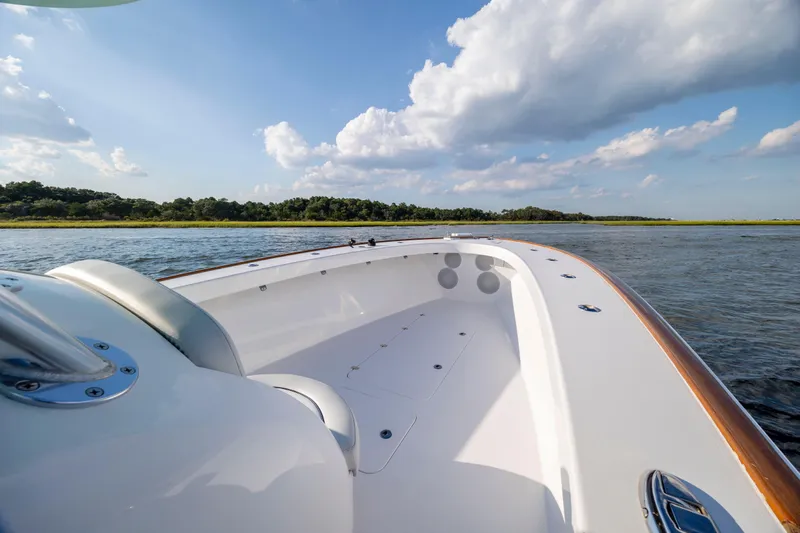  Yacht Photos Pics 2018 Tribute 37 boat on calm water under a blue sky with clouds.