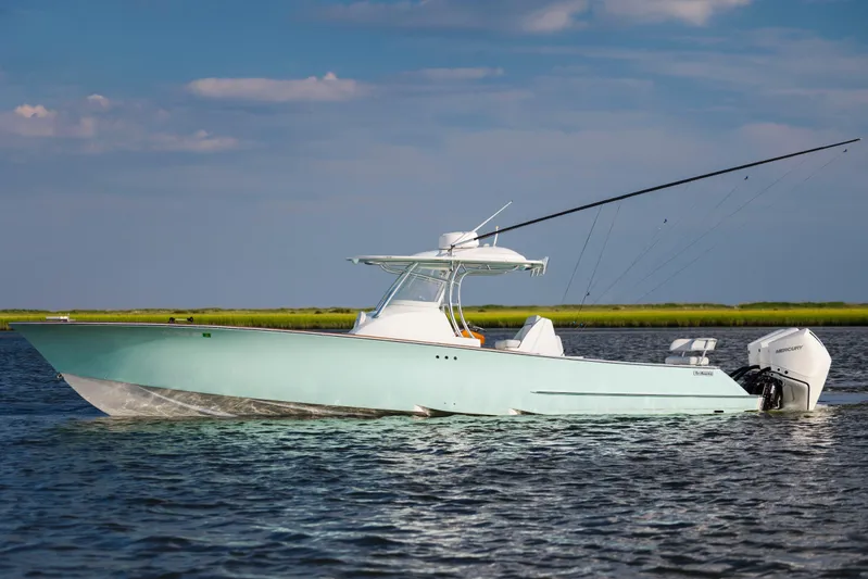  Yacht Photos Pics 2018 Tribute 37 boat on water, clear sky, fishing rods visible.