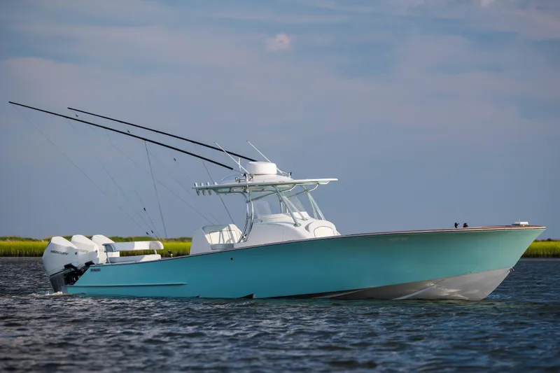  Yacht Photos Pics 2018 Tribute 37 boat on water with fishing rods and outboard motors.