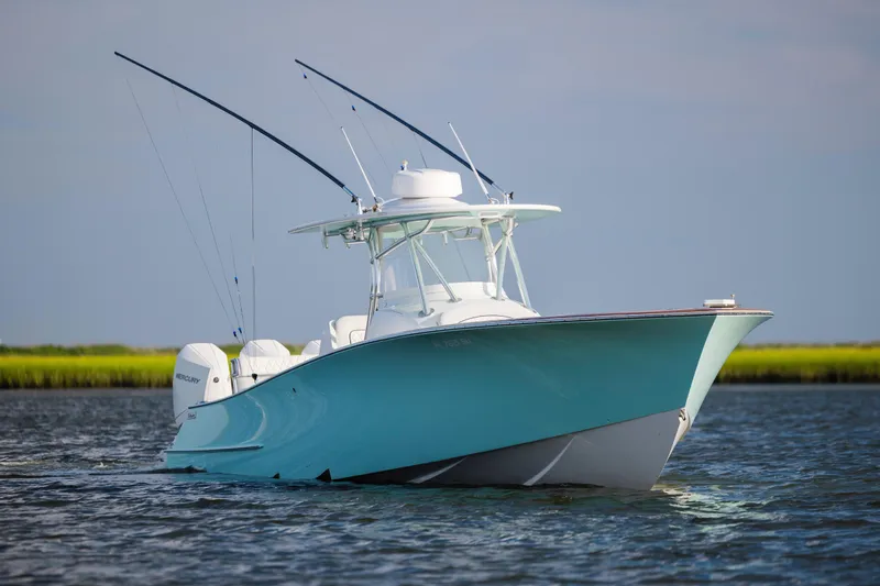  Yacht Photos Pics 2018 Tribute 37 boat on water with dual Mercury engines, clear sky background.