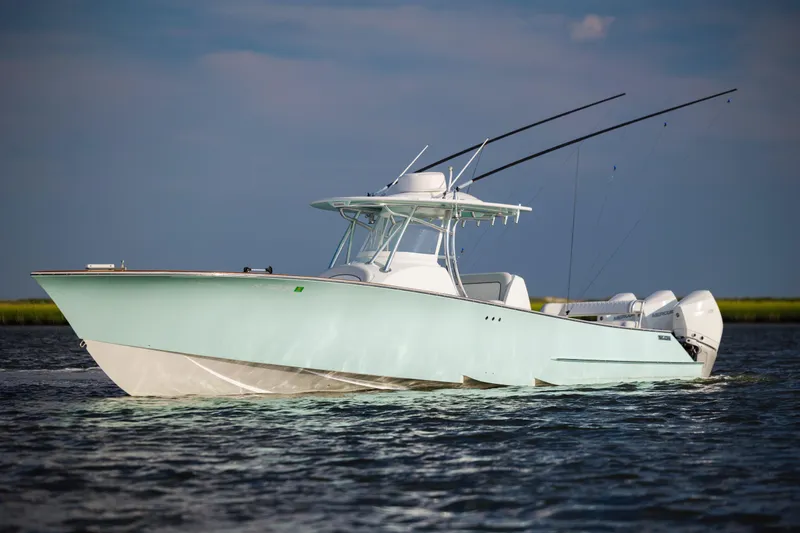  Yacht Photos Pics 2018 Tribute 37 boat on water, featuring sleek design and dual outboard engines.