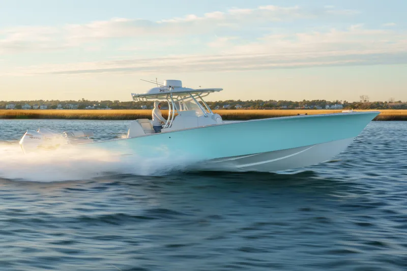  Yacht Photos Pics 2018 Tribute 37 boat speeding on water, scenic background.