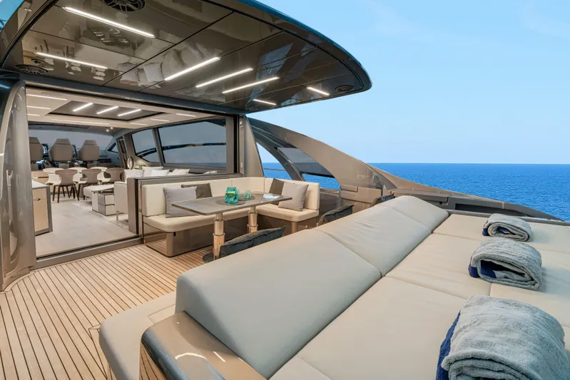 Silver Bullet Yacht Photos Pics Luxurious 2022 Pershing 8X yacht interior with ocean view, featuring elegant seating and modern design.