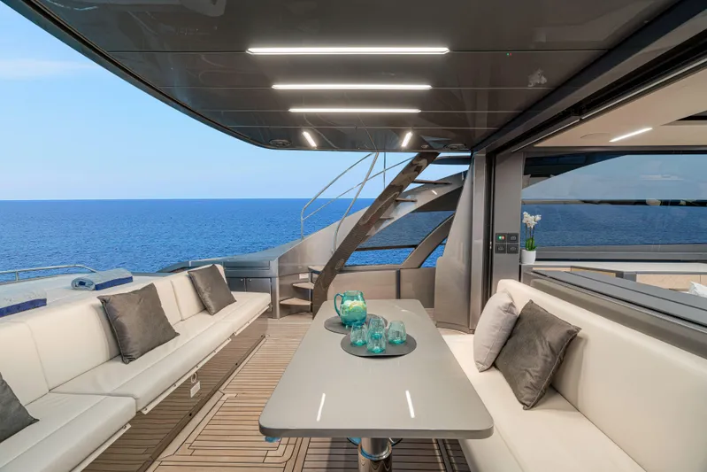 Silver Bullet Yacht Photos Pics Luxurious 2022 Pershing 8X yacht interior with ocean view, modern seating, and elegant decor.