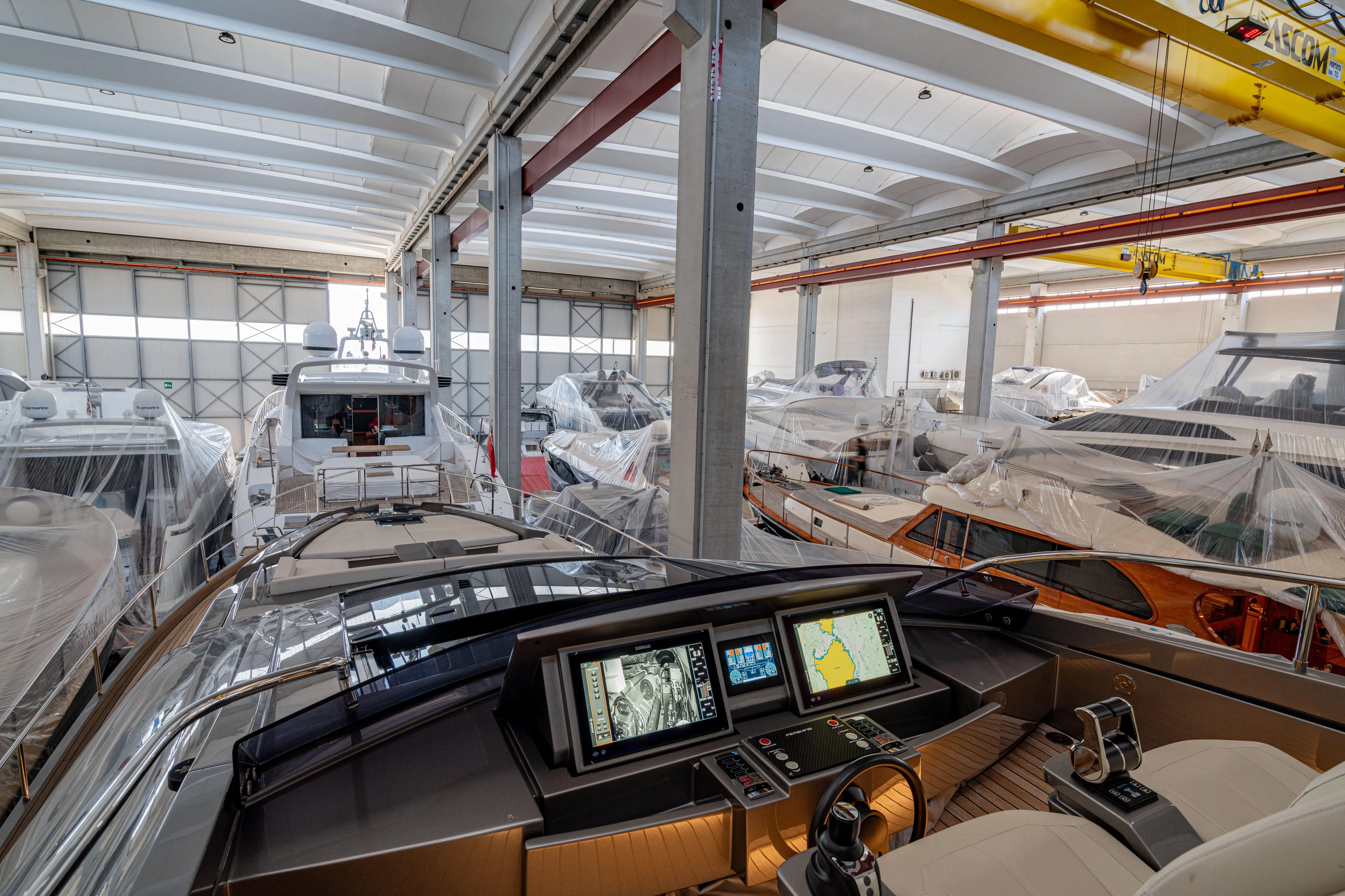 Silver Bullet Yacht Photos Pics Pershing 8X 2022 yacht in a storage facility, featuring advanced navigation systems.