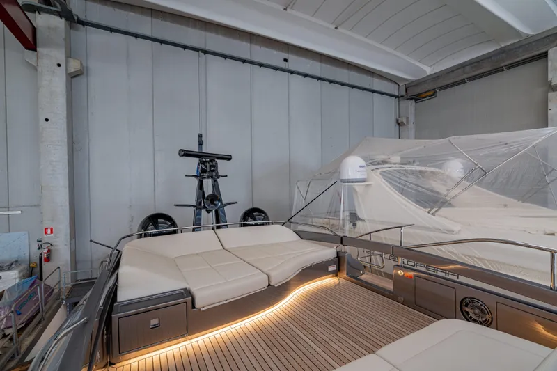Silver Bullet Yacht Photos Pics 2022 Pershing 8X yacht interior with sleek design and ambient lighting in a storage facility.