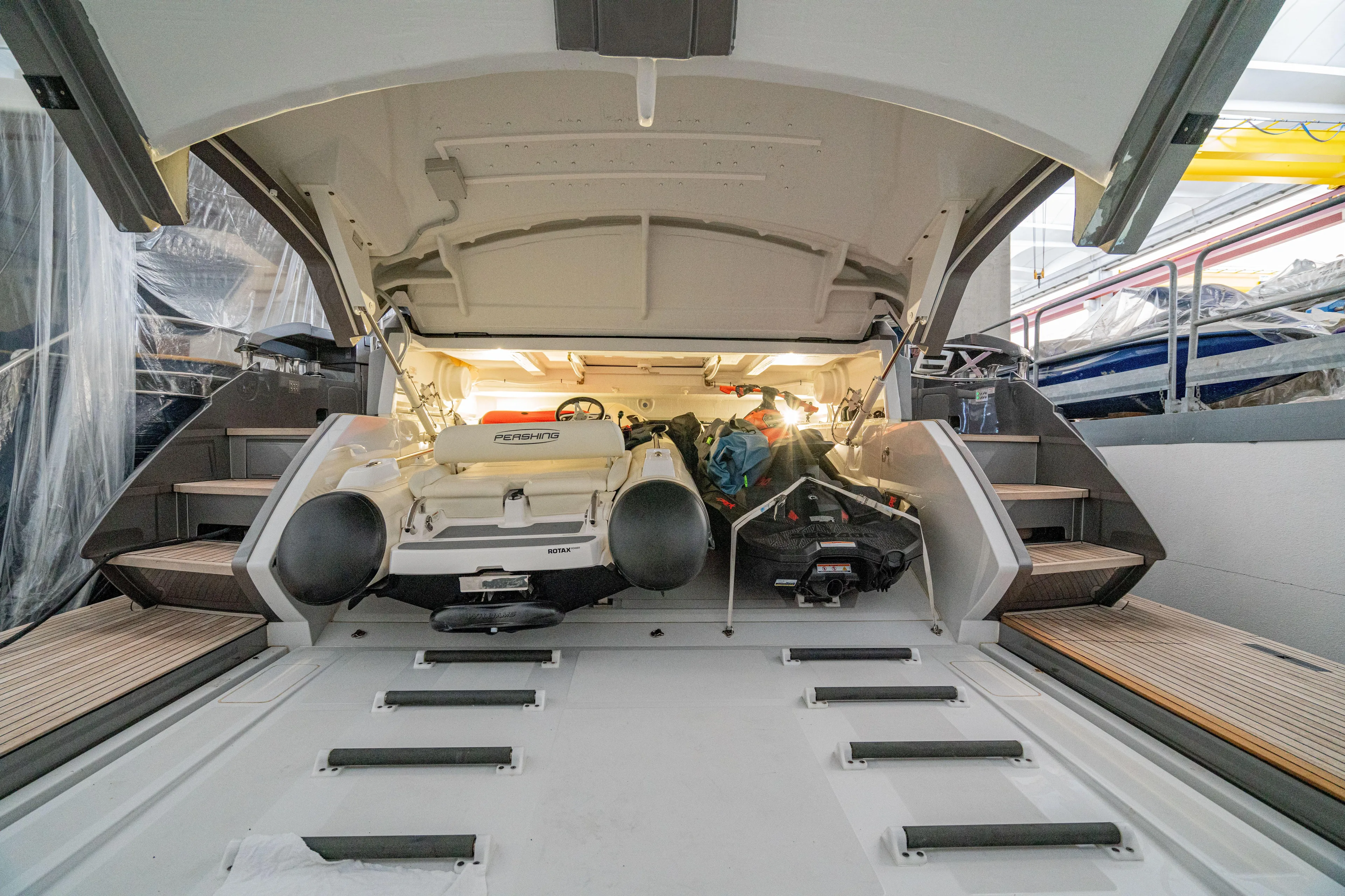 Silver Bullet Yacht Photos Pics 2022 Pershing 8X yacht garage with stored watercraft and equipment.