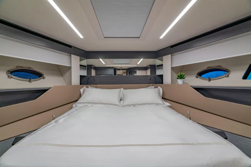 Silver Bullet Yacht Photos Pics Luxurious bedroom interior of 2022 Pershing 8X yacht with modern design and elegant bedding.