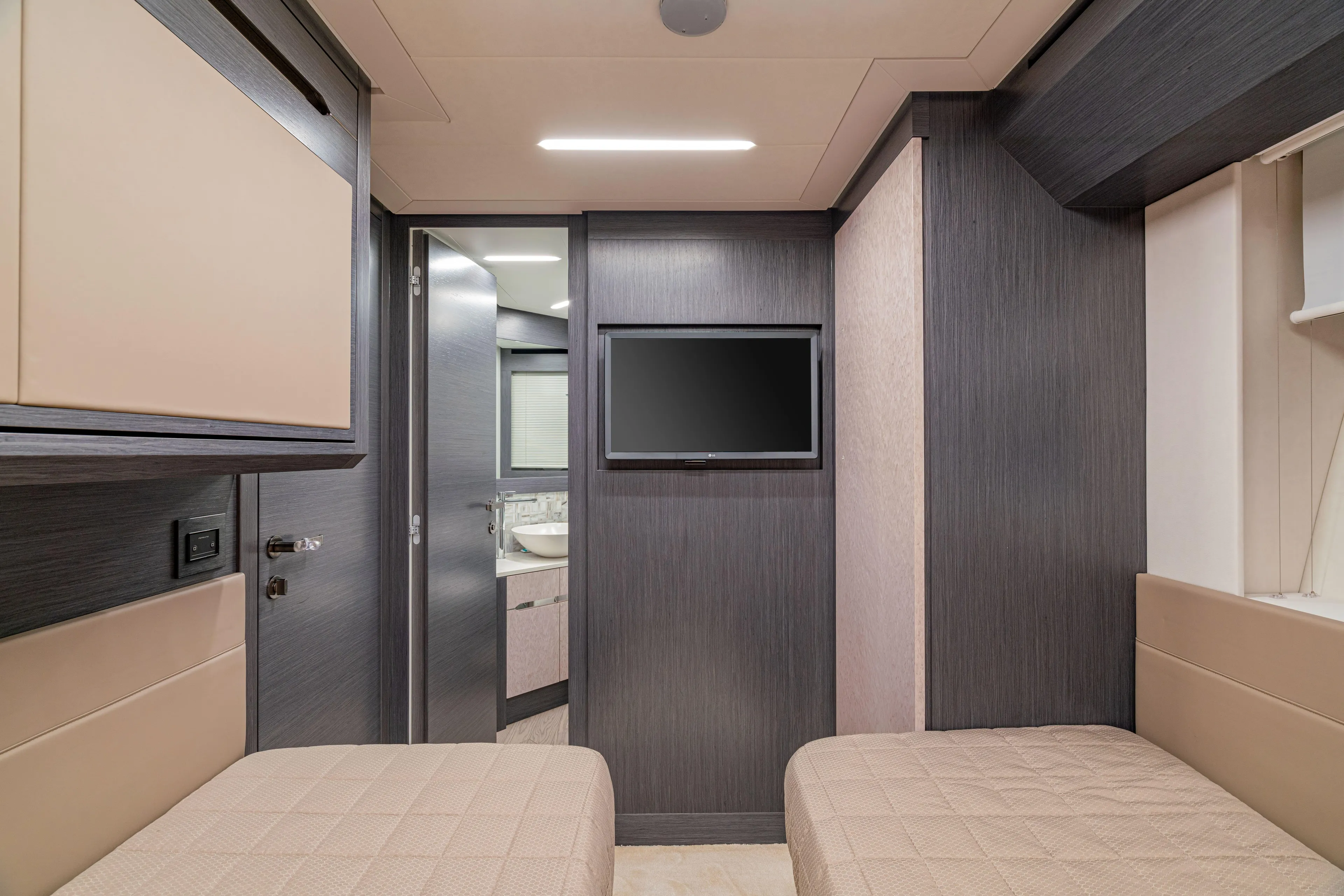 Silver Bullet Yacht Photos Pics Interior of 2022 Pershing 8X yacht cabin with twin beds and wall-mounted TV.