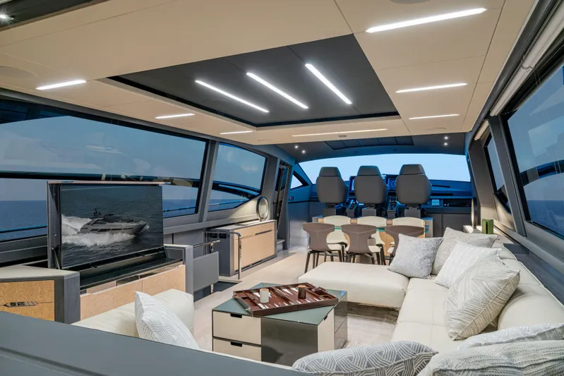 Silver Bullet Yacht Photos Pics Luxurious interior of 2022 Pershing 8X yacht with modern seating and panoramic windows.