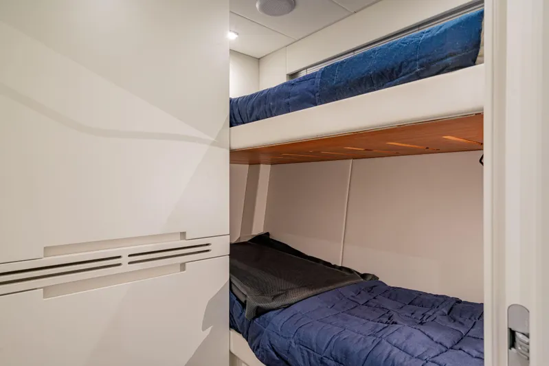 Silver Bullet Yacht Photos Pics Bunk beds in a 2022 Pershing 8X yacht cabin with modern design.