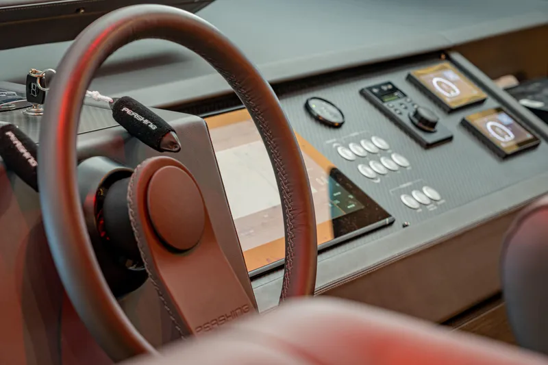 Silver Bullet Yacht Photos Pics Steering wheel and dashboard of 2022 Pershing 8X yacht, featuring modern controls and displays.
