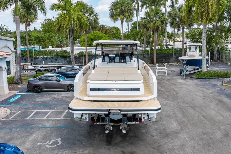  Yacht Photos Pics 2025 De Antonio Yachts D36 OPEN docked, surrounded by palm trees and parked cars.