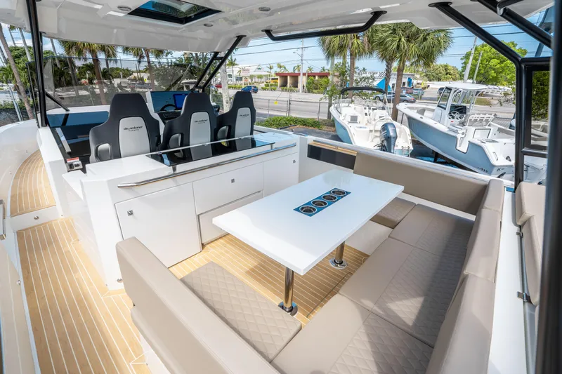  Yacht Photos Pics 2025 De Antonio Yachts D36 OPEN interior with seating and helm, showcasing modern design.