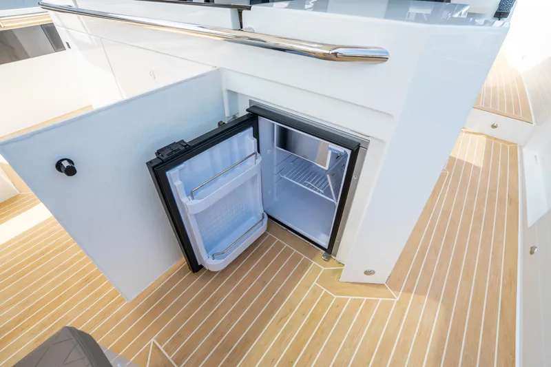  Yacht Photos Pics Open mini fridge on De Antonio Yachts D36 OPEN, 2025 model, with wooden deck flooring.