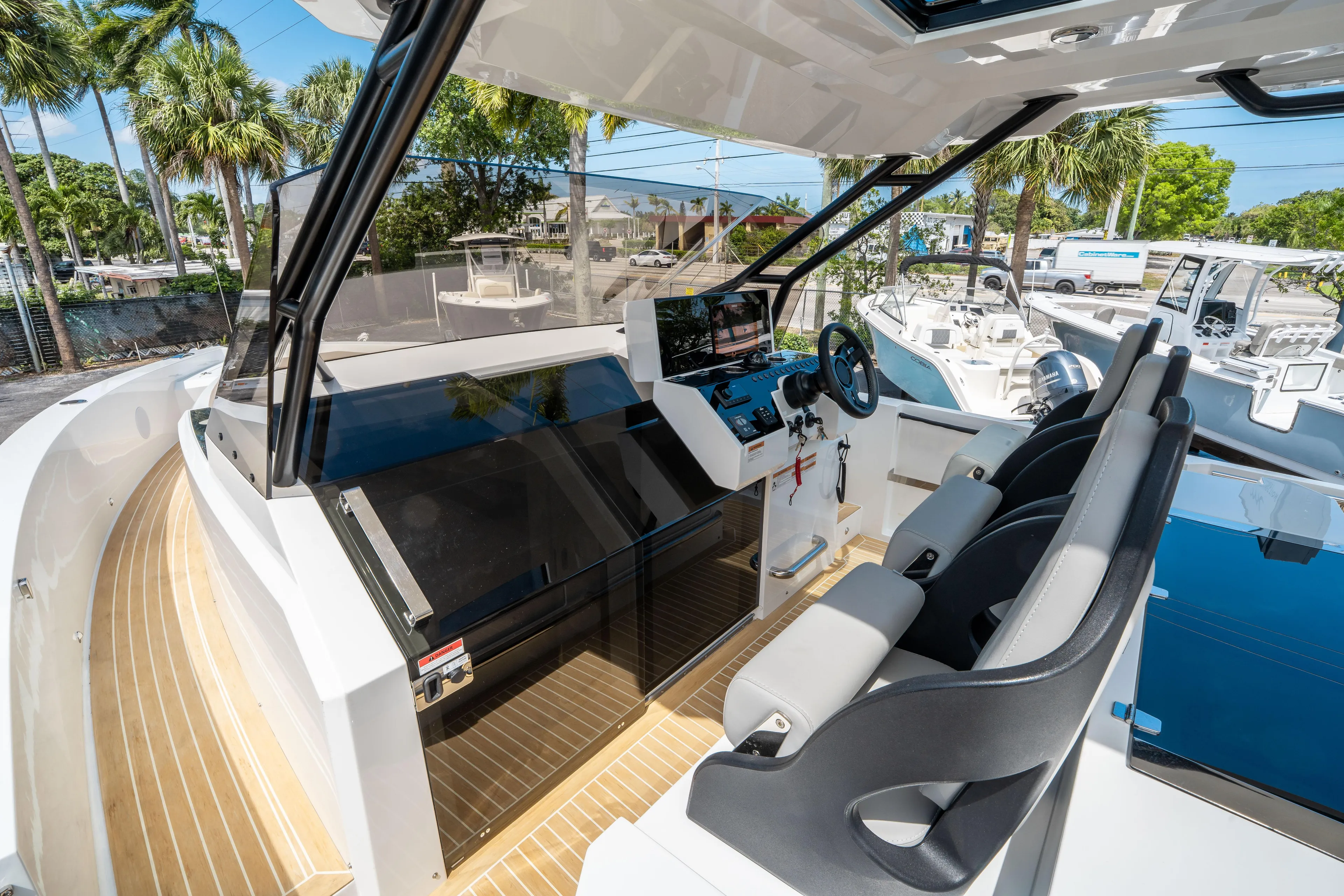  Yacht Photos Pics 2025 De Antonio Yachts D36 OPEN cockpit with modern helm and seating, surrounded by palm trees.