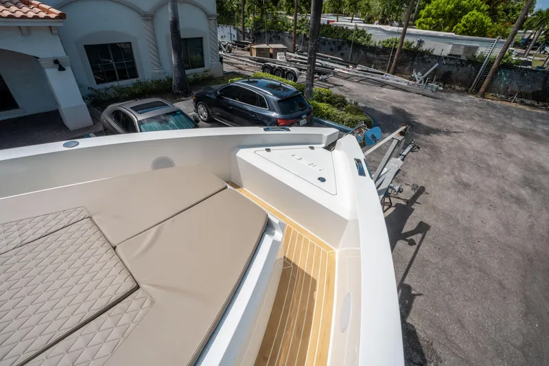  Yacht Photos Pics 2025 De Antonio Yachts D36 OPEN with beige seating, parked near vehicles and trailers.