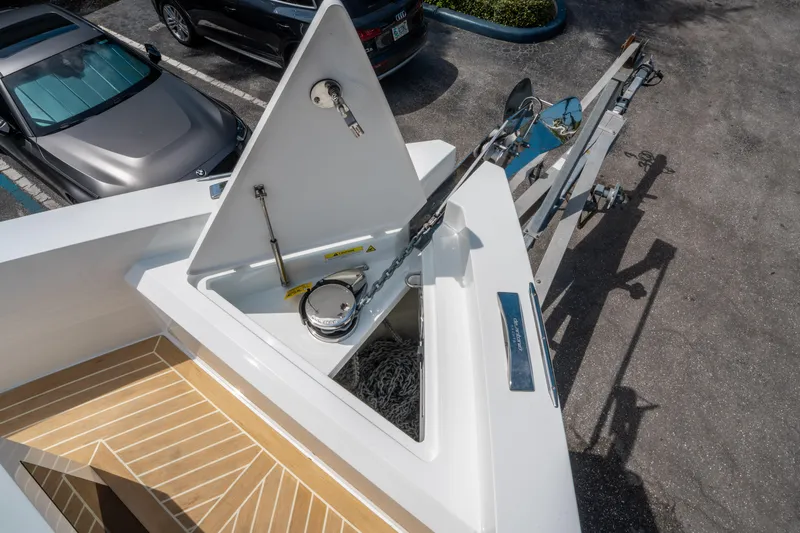  Yacht Photos Pics 2025 De Antonio Yachts D36 OPEN anchor compartment with chain and winch, parked nearby cars.