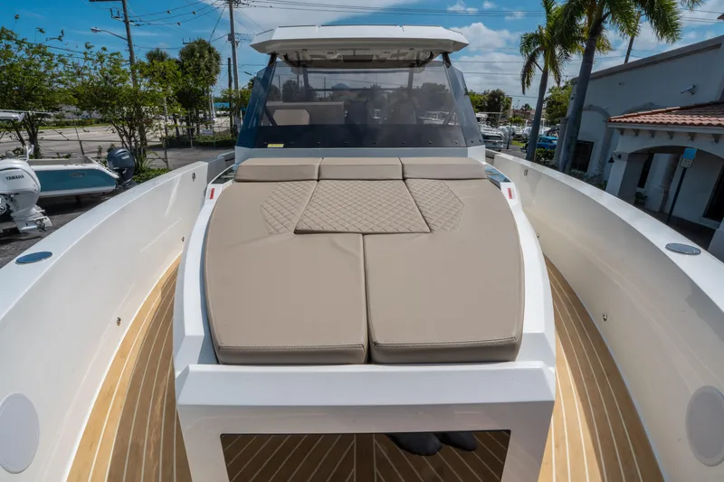  Yacht Photos Pics 2025 De Antonio Yachts D36 OPEN with beige sunbed, docked under clear skies.