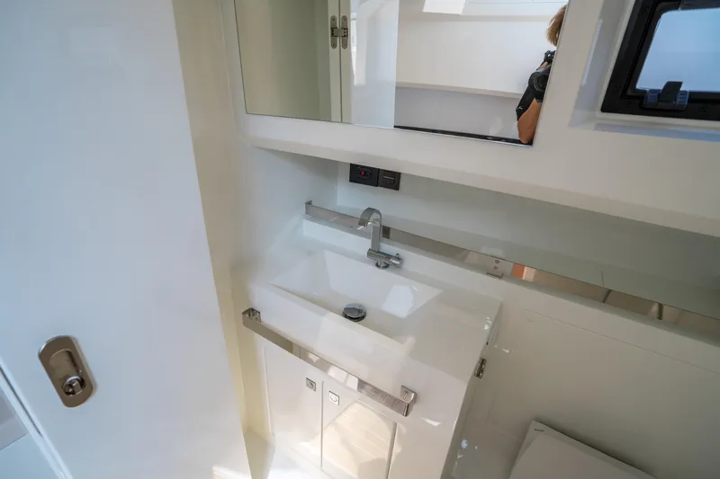  Yacht Photos Pics Modern bathroom interior of 2025 De Antonio Yachts D36 OPEN, featuring sleek sink and mirror.