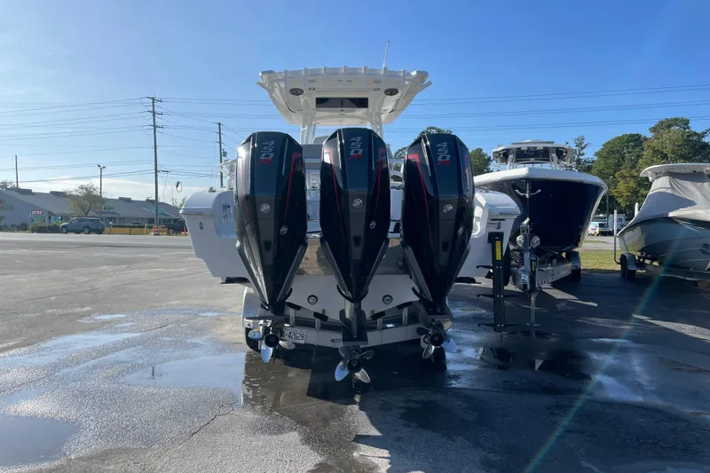  Yacht Photos Pics 2020 Fountain 38 Center Console with triple outboard engines in a parking lot.