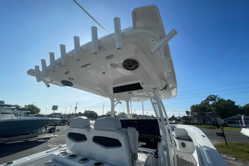  Yacht Photos Pics 2020 Fountain 38 Center Console boat with rod holders and seating, under clear blue sky.