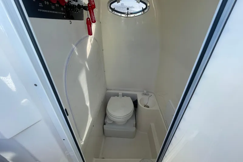  Yacht Photos Pics 2020 Fountain 38 Center Console boat interior with compact marine toilet.