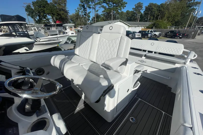  Yacht Photos Pics 2020 Fountain 38 Center Console boat with white seating and steering wheel, docked outdoors.