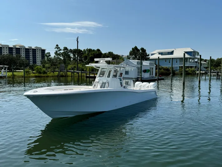  Yacht Photos Pics 2023 Invincible 36 Open Fisherman boat on calm water near docks.