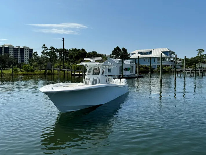  Yacht Photos Pics 2023 Invincible 36 Open Fisherman boat on calm water near docks.