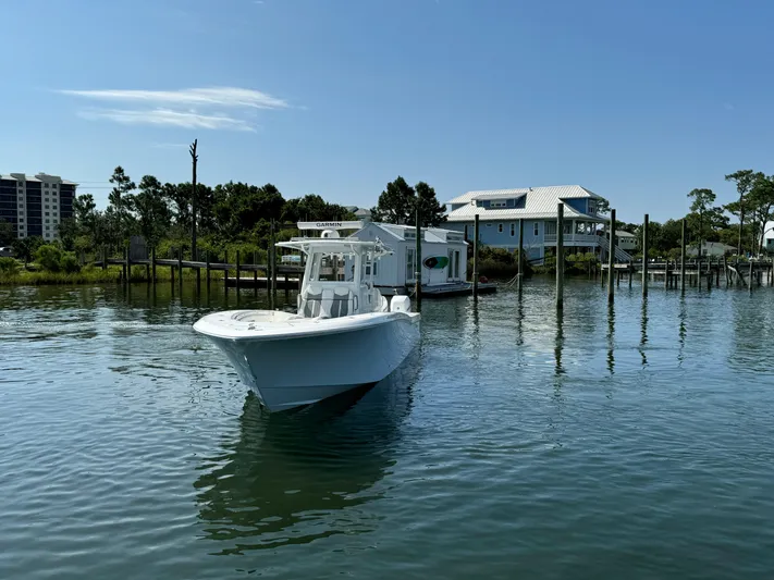  Yacht Photos Pics 2023 Invincible 36 Open Fisherman boat on calm water near docks.
