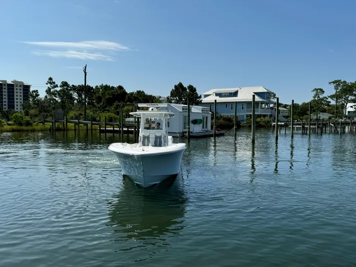 Yacht Photos Pics 2023 Invincible 36 Open Fisherman boat on calm water near docks.