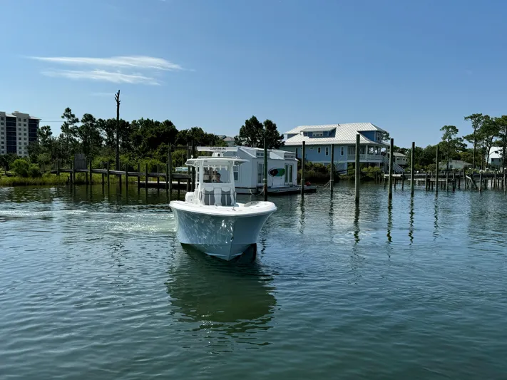  Yacht Photos Pics 2023 Invincible 36 Open Fisherman boat cruising in a serene waterfront setting.