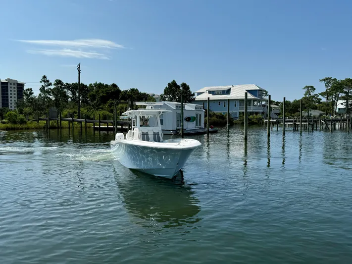  Yacht Photos Pics 2023 Invincible 36 Open Fisherman boat cruising on a calm waterway.