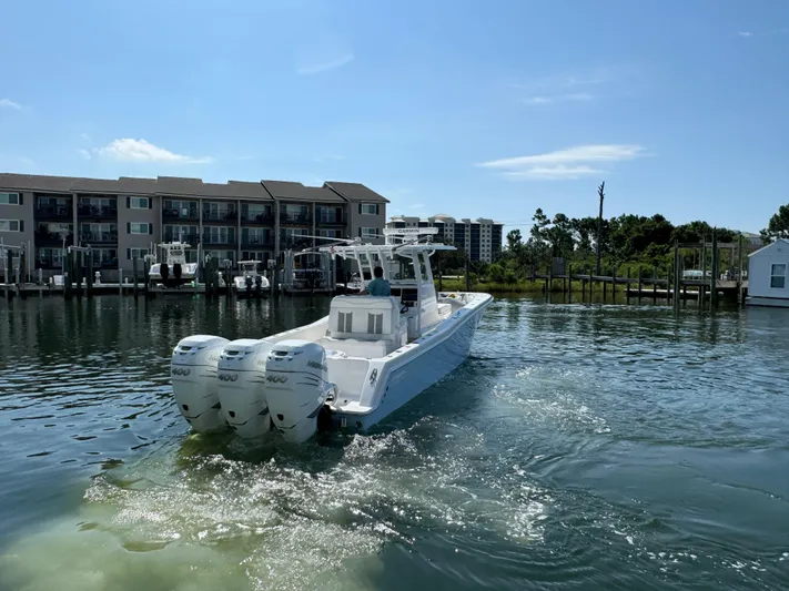  Yacht Photos Pics 2023 Invincible 36 Open Fisherman boat on calm water near docks.
