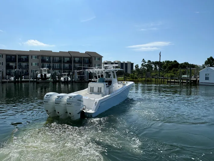  Yacht Photos Pics 2023 Invincible 36 Open Fisherman boat on water near docks and buildings.