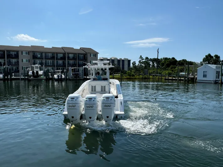  Yacht Photos Pics 2023 Invincible 36 Open Fisherman boat on water near docks and buildings.