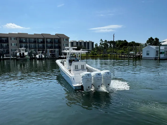  Yacht Photos Pics 2023 Invincible 36 Open Fisherman boat on calm water near docks.