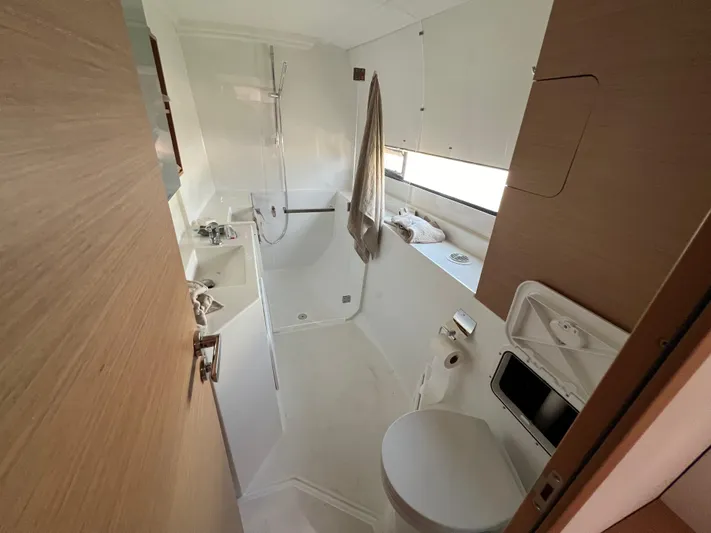 Sia Yacht Photos Pics Modern bathroom in 2022 Excess XCS 11 yacht, featuring shower, sink, and toilet.