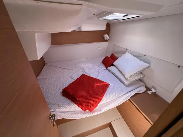 Sia Yacht Photos Pics Cozy cabin interior of 2022 Excess XCS 11 with bed and red accents.