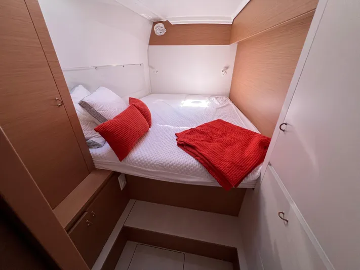 Sia Yacht Photos Pics Cozy cabin interior of 2022 Excess XCS 11 with red accents and wood finish.
